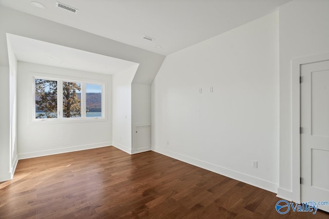 bonus room with wood-type flooring and lofted ceiling