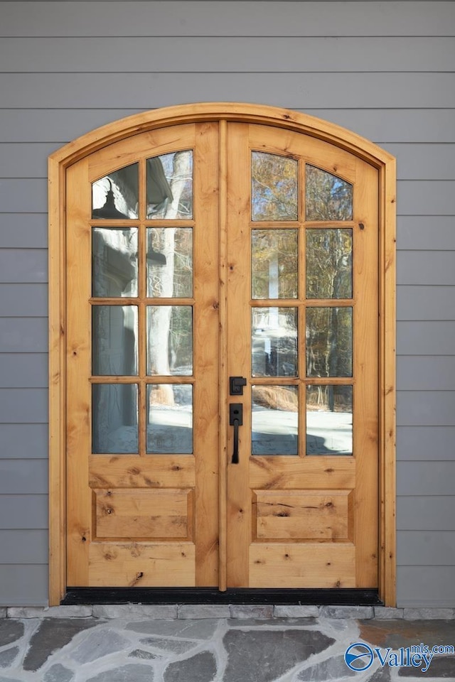 doorway to outside featuring wood walls