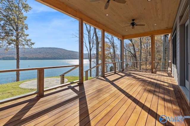 wooden deck featuring ceiling fan and a water and mountain view