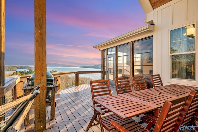 deck at dusk with outdoor dining space