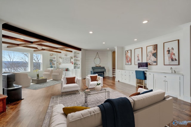 living room with crown molding, a fireplace, recessed lighting, wood finished floors, and beamed ceiling