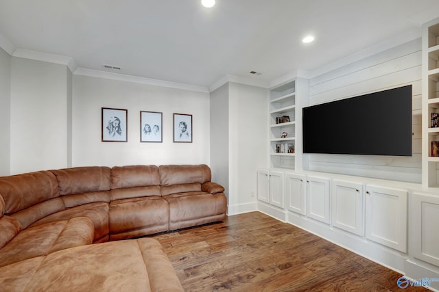 unfurnished living room with built in features, visible vents, wood finished floors, and ornamental molding