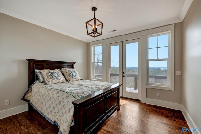 bedroom featuring access to outside, ornamental molding, french doors, and hardwood / wood-style floors