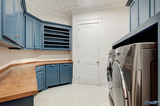 washroom with light tile patterned flooring, separate washer and dryer, cabinets, and ornamental molding