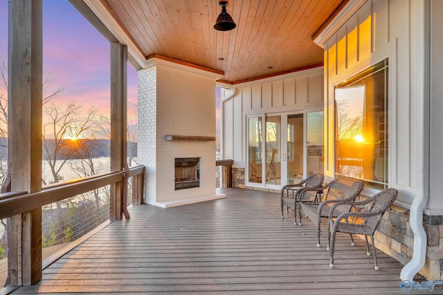 sunroom with a brick fireplace and wooden ceiling