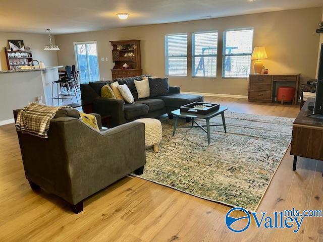 living room featuring light wood finished floors and baseboards