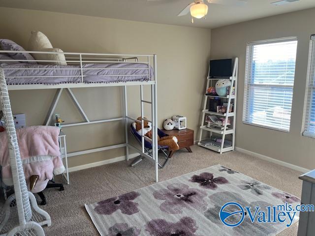 bedroom with ceiling fan, carpet, and baseboards