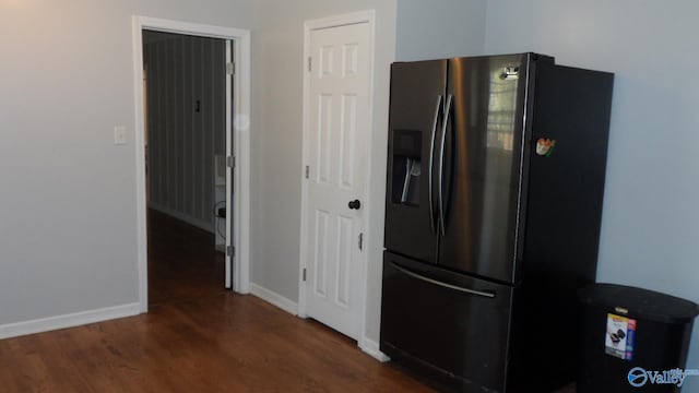 kitchen with stainless steel fridge and dark hardwood / wood-style floors