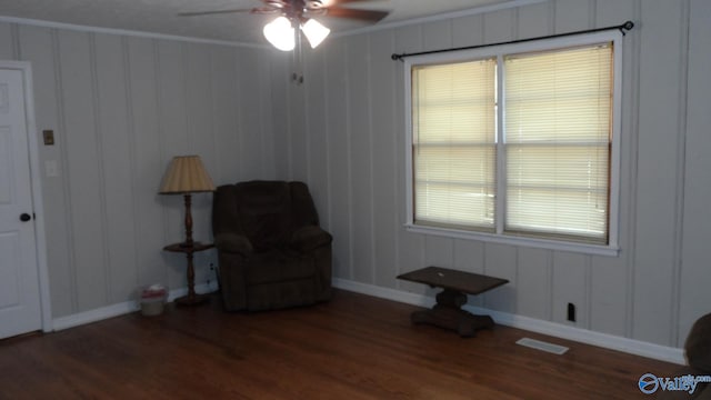 unfurnished room with ceiling fan, crown molding, and dark wood-type flooring