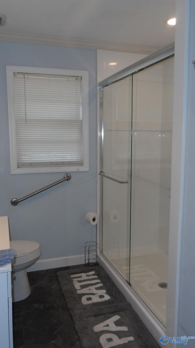 bathroom with vanity, crown molding, and walk in shower