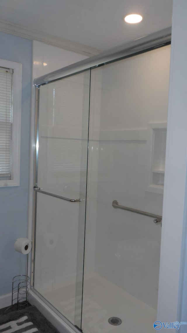 bathroom featuring a shower with shower door