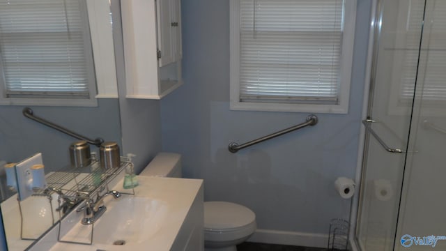 bathroom with vanity, toilet, and an enclosed shower