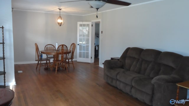 dining area featuring dark hardwood / wood-style floors, ceiling fan, and crown molding