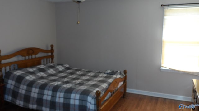 bedroom with hardwood / wood-style flooring