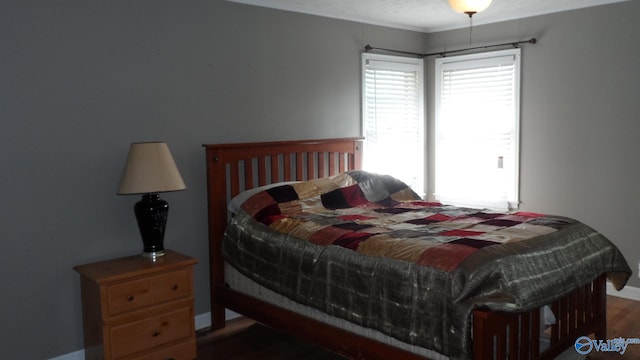 bedroom with dark wood-type flooring