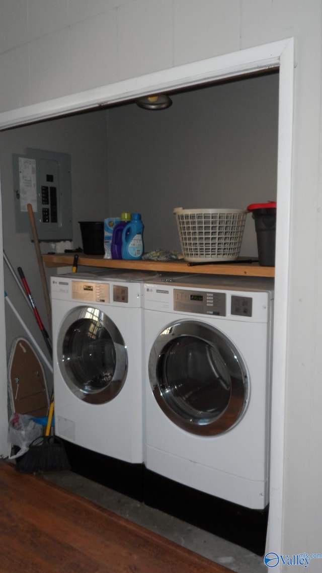 clothes washing area with electric panel and washing machine and dryer