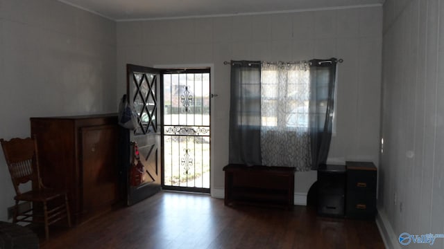 foyer featuring hardwood / wood-style floors and crown molding