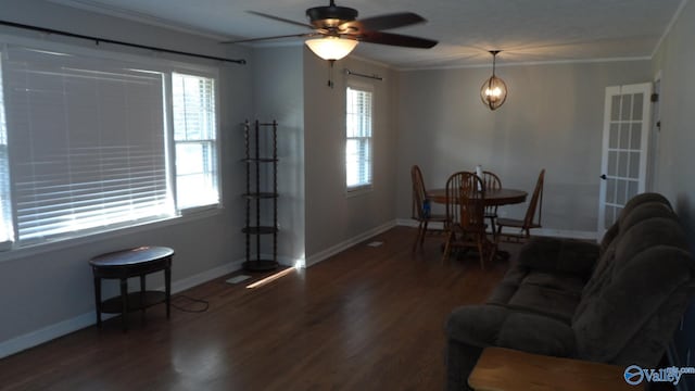 living room with ceiling fan, dark hardwood / wood-style flooring, and ornamental molding