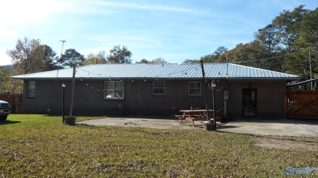 back of house with a lawn