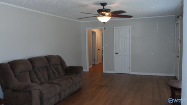 living room with ornamental molding, a textured ceiling, ceiling fan, and dark wood-type flooring