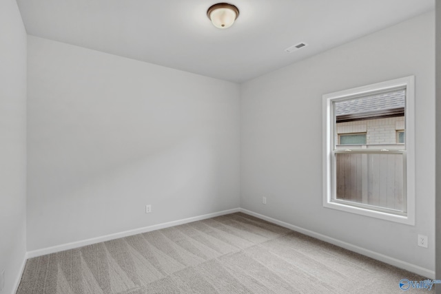 unfurnished room with light carpet