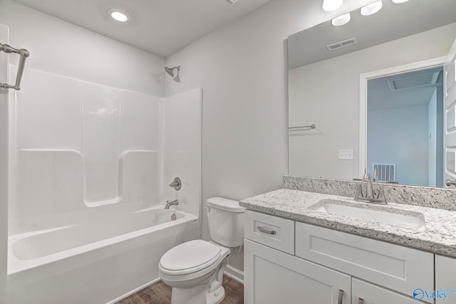 full bathroom featuring hardwood / wood-style flooring, vanity, shower / bathtub combination, and toilet