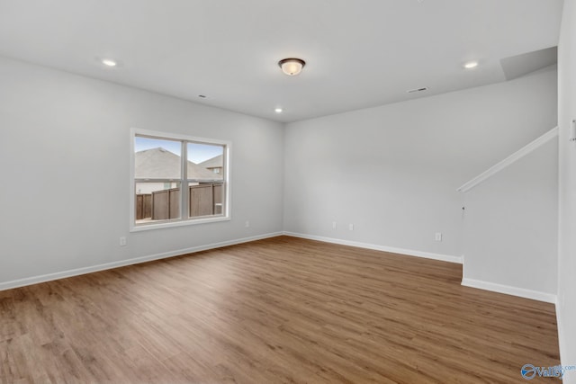 unfurnished room featuring hardwood / wood-style flooring