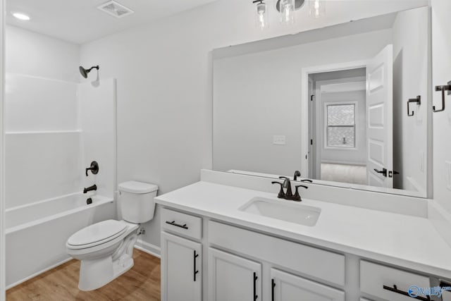 full bathroom with hardwood / wood-style floors, vanity, toilet, and bathing tub / shower combination