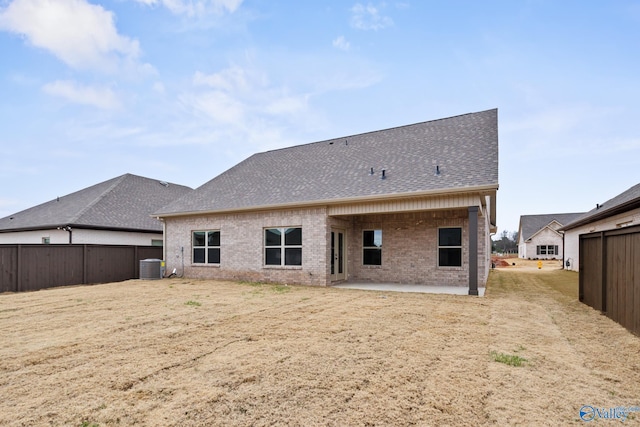 back of property with central AC unit and a patio area