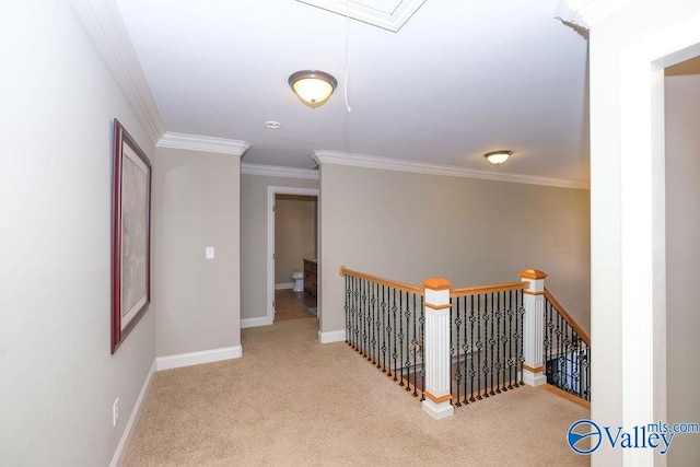 hallway with ornamental molding and light colored carpet