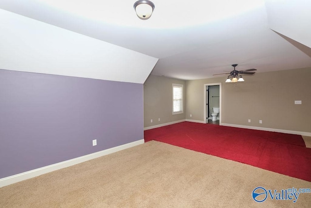 bonus room with vaulted ceiling, ceiling fan, and carpet floors