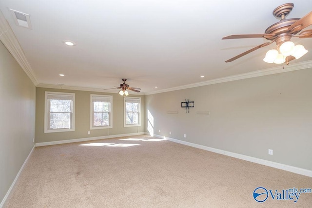 unfurnished room with ceiling fan, light colored carpet, and ornamental molding