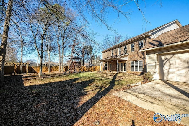 view of yard with a garage and a playground