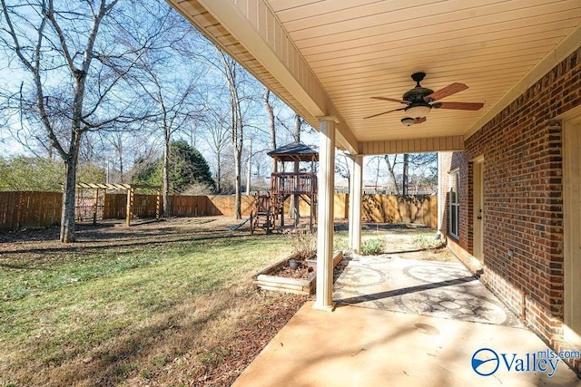 view of yard featuring a playground, a patio area, and ceiling fan