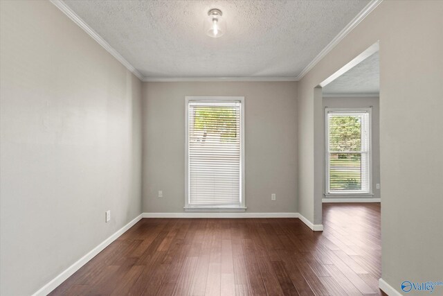 11021 Jean Rd SE, Huntsville, AL 35803 - unfurnished room with a textured ceiling, dark wood-style flooring, and a healthy amount of sunlight