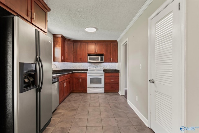11021 Jean Rd SE, Huntsville, AL 35803 - kitchen featuring stainless steel appliances, a sink, a textured ceiling, light tile patterned flooring, and dark countertops
