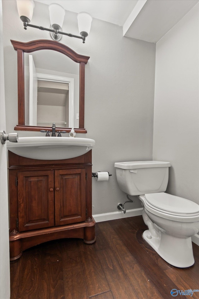 11021 Jean Rd SE, Huntsville, AL 35803 - half bath with baseboards, toilet, vanity, and wood finished floors