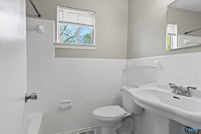 11021 Jean Rd SE, Huntsville, AL 35803 - bathroom with tile walls, visible vents, toilet, and wainscoting