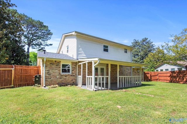 11021 Jean Rd SE, Huntsville, AL 35803 - rear view of house with a lawn, french doors, a fenced backyard, a patio, and brick siding