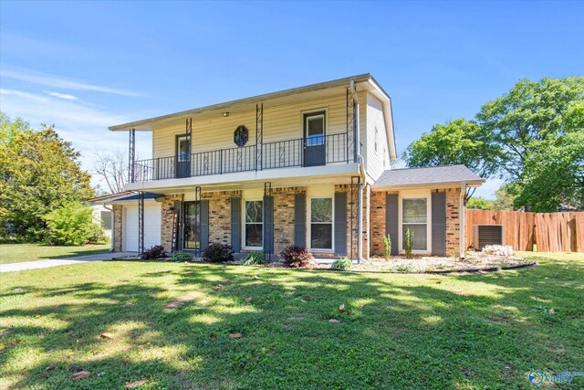 11021 Jean Rd SE, Huntsville, AL 35803 - front facade featuring fence, a front lawn, a balcony, and concrete driveway