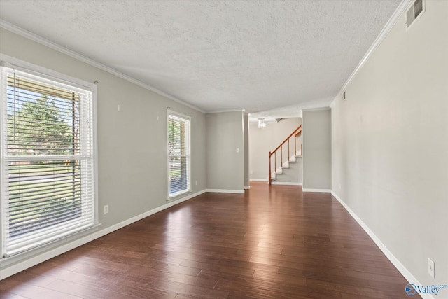 11021 Jean Rd SE, Huntsville, AL 35803 - unfurnished living room featuring a textured ceiling, dark wood-type flooring, and ornamental molding