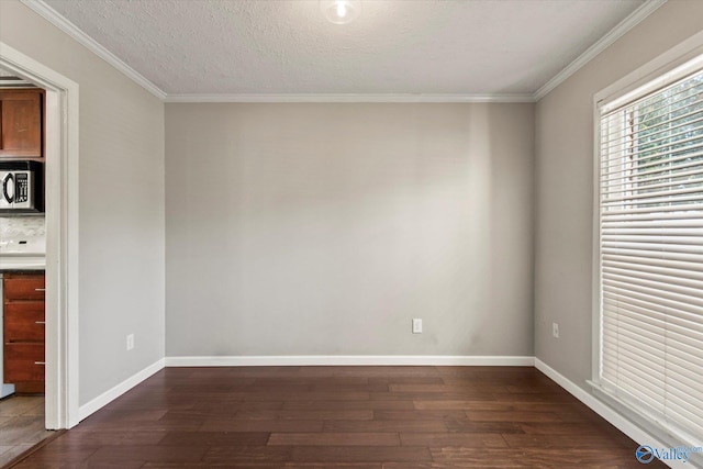 11021 Jean Rd SE, Huntsville, AL 35803 - spare room featuring baseboards, ornamental molding, and dark wood-style floors