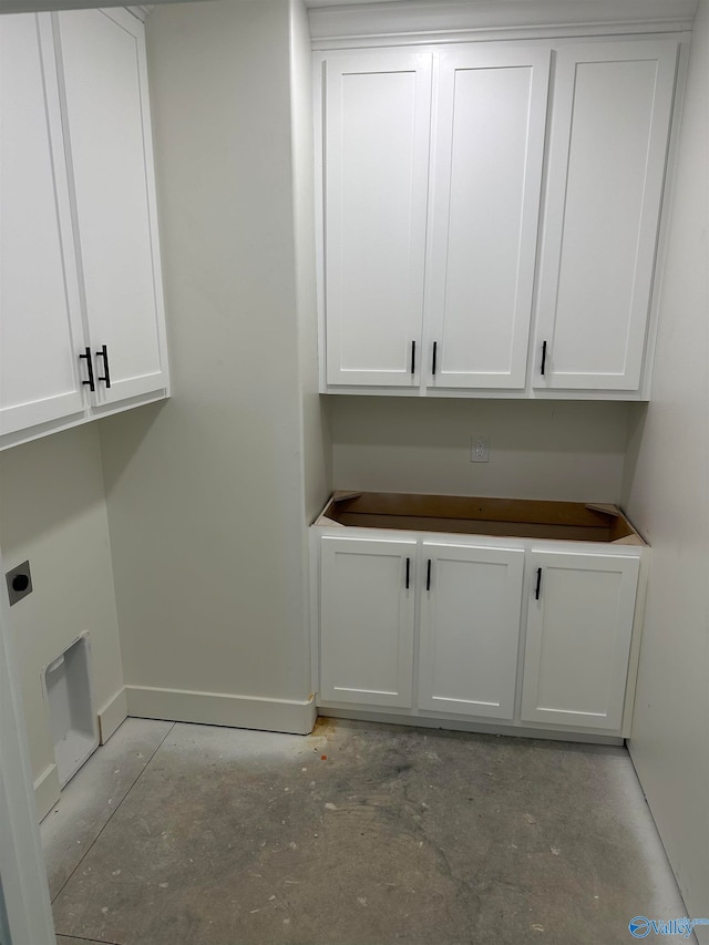 laundry room featuring baseboards, cabinet space, and hookup for an electric dryer