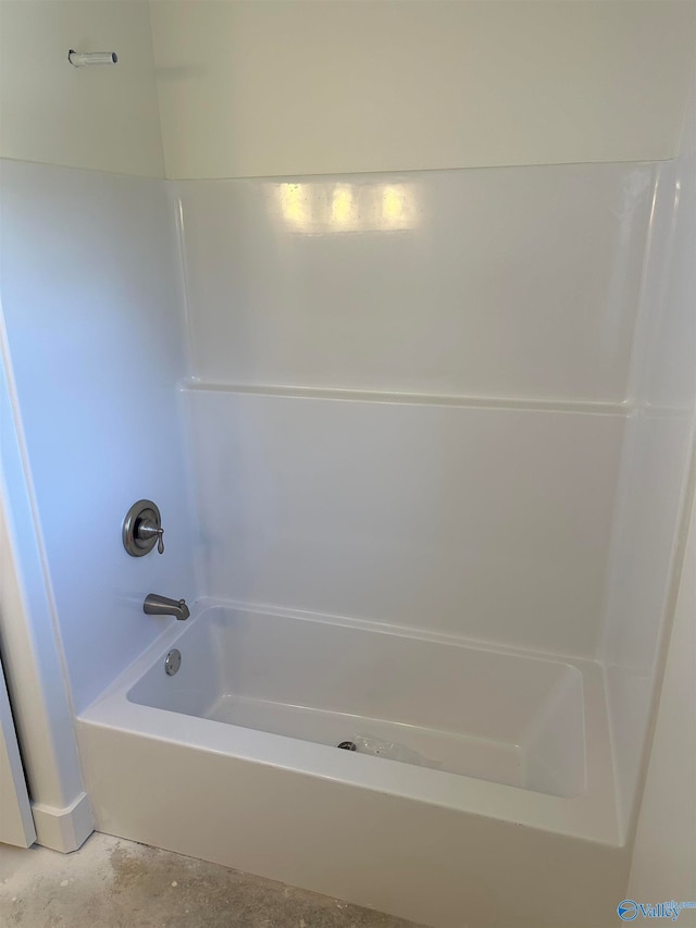 bathroom featuring concrete floors and tub / shower combination