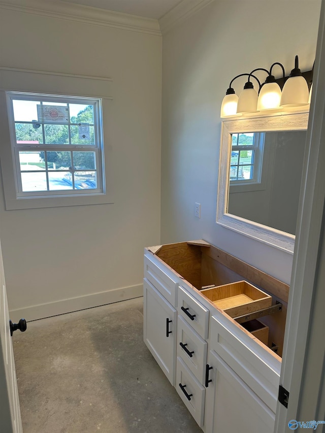 bathroom featuring concrete flooring, crown molding, plenty of natural light, and baseboards