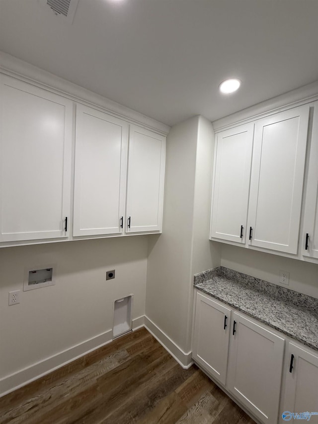 clothes washing area with cabinet space, baseboards, dark wood finished floors, hookup for a washing machine, and hookup for an electric dryer