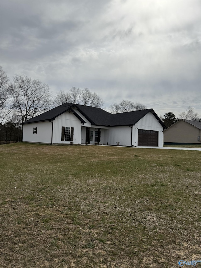 view of front of home with a garage and a front lawn