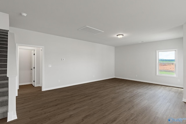 unfurnished room with dark hardwood / wood-style floors