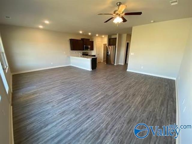 unfurnished living room with dark hardwood / wood-style floors and ceiling fan