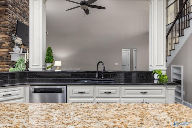 kitchen featuring a sink, stainless steel dishwasher, ceiling fan, and white cabinets